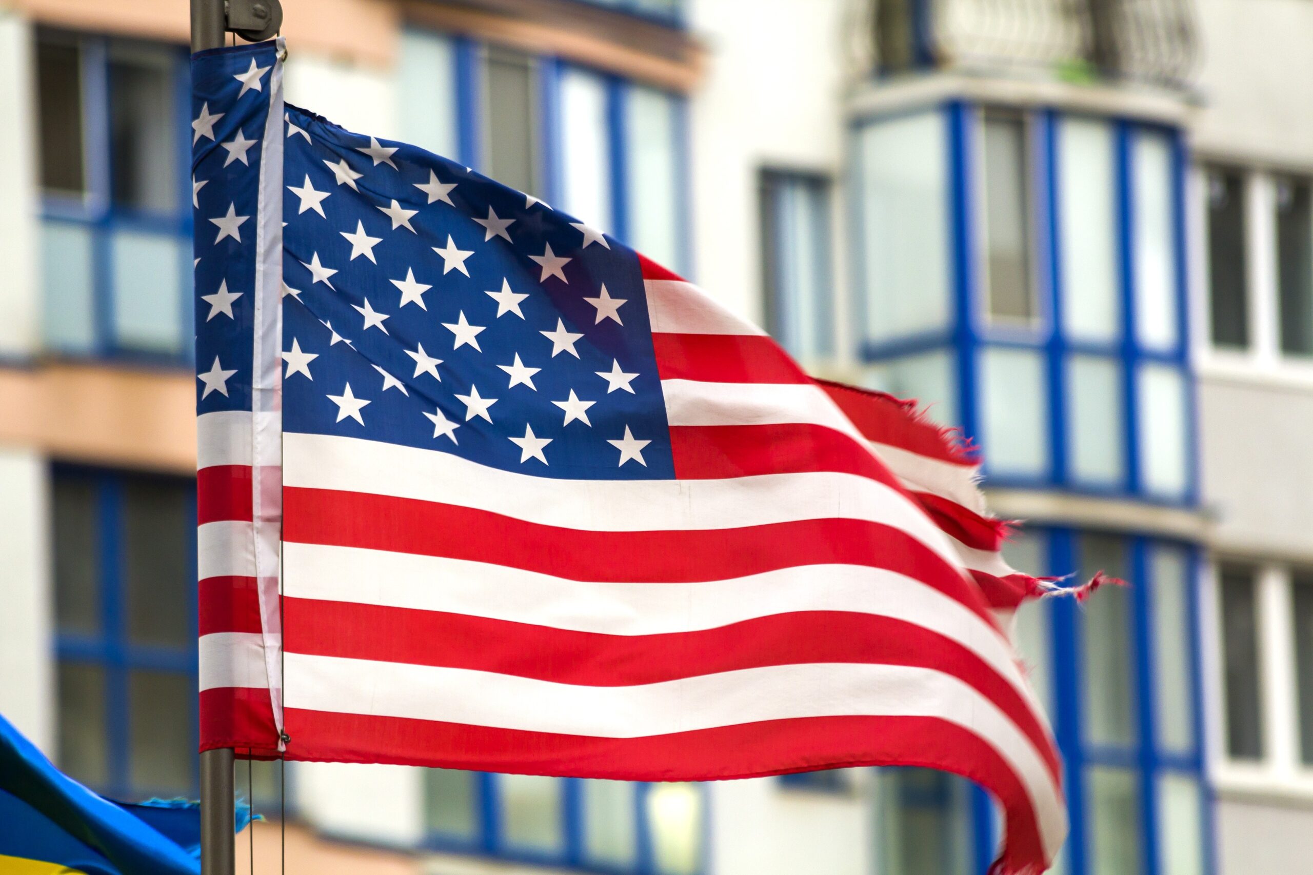 close up of the us flag against city skyline